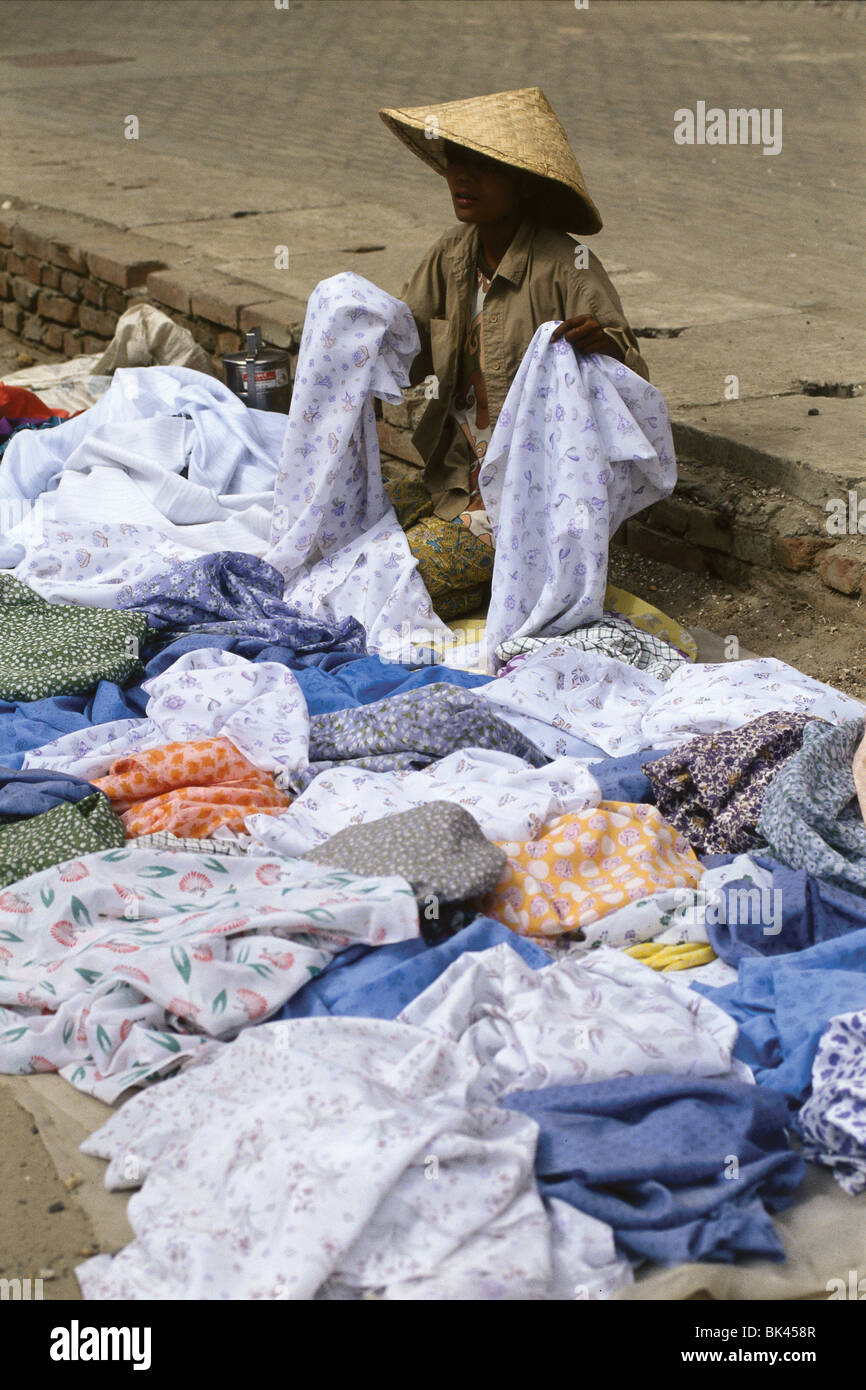 Street vendor displaying a variety of fabrics, Myanmar Stock Photo