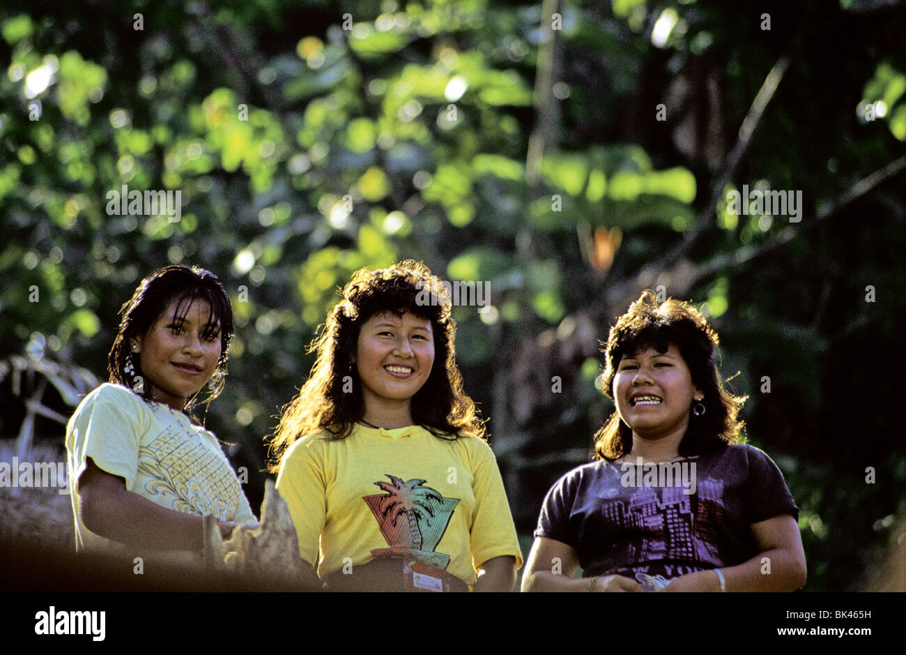 Three young women along the Aguarico River, Ecuador Stock Photo