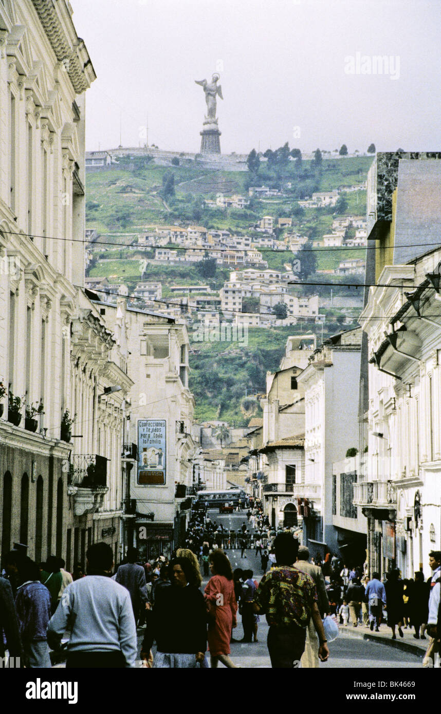 Street scene in Quito, Ecuador showing the monumental statue of winged Virgin on El Panecillo Hill in the distance Stock Photo