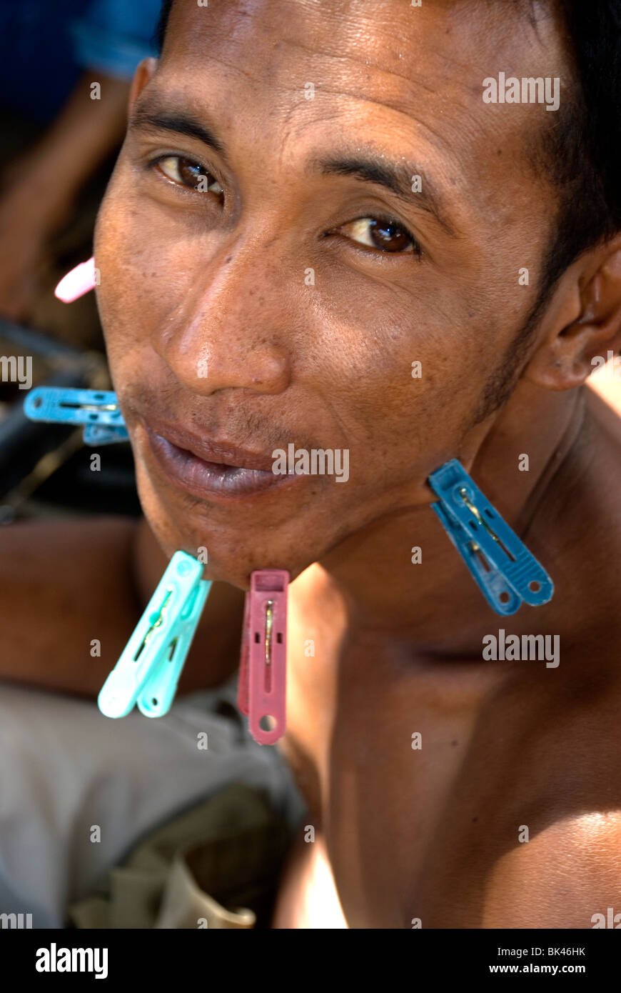 man playing cards with pegs in kupang, west timor, indonesia Stock Photo