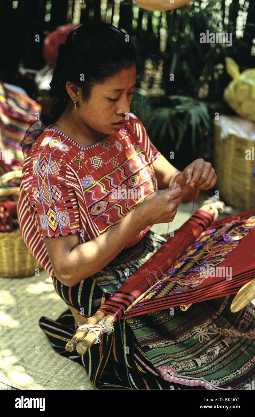 A weaver working with textiles on a backstrap loom, Guatemala Stock Photo