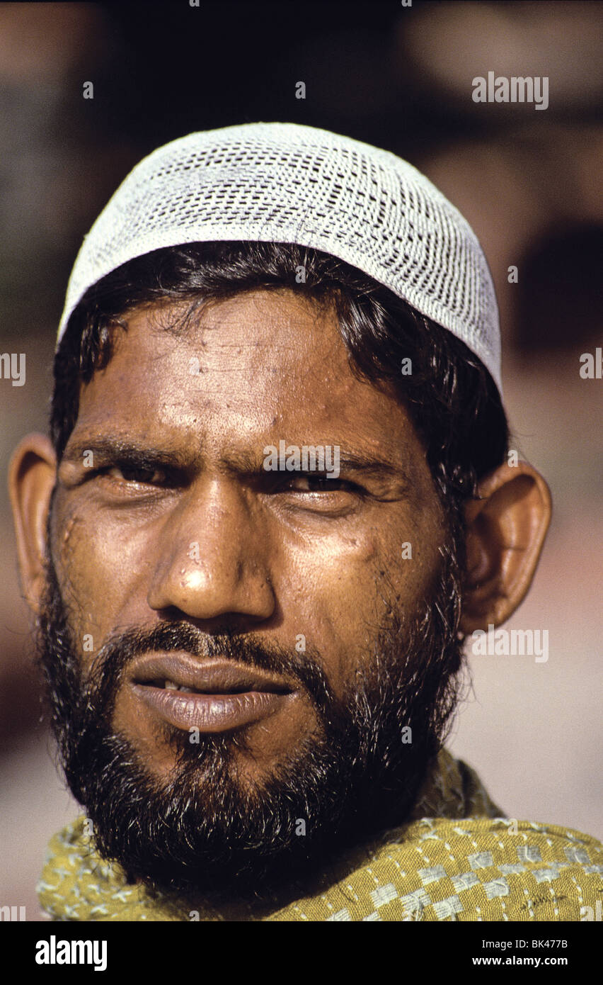 Portrait of a young Indian man wearing a white knit kufi skull-cap, India Stock Photo