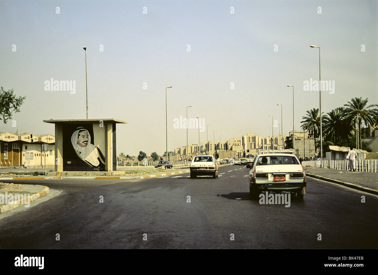 Baghdad street scene with a billboard of Saddam Hussein, Iraq 1991 Stock Photo