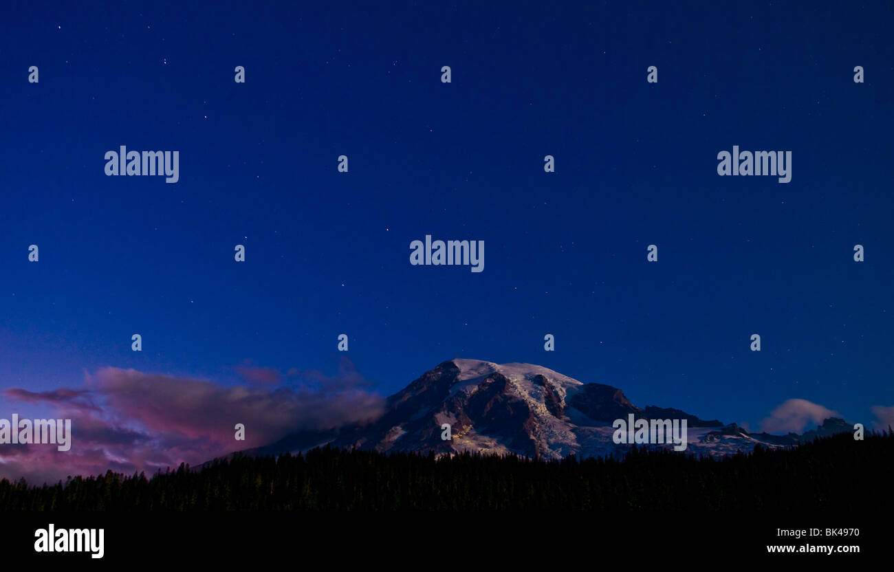 Night shot of Mount Rainier with stars in the night sky. Stock Photo