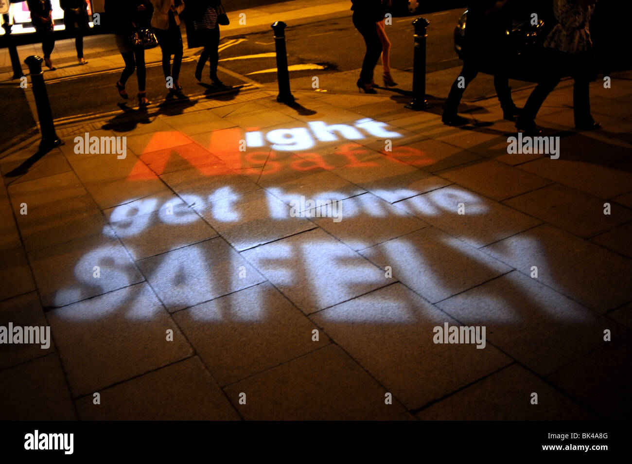 Night Safe Get Home Safely police signs beamed on to the street in Harrogate Yorkshire UK Stock Photo
