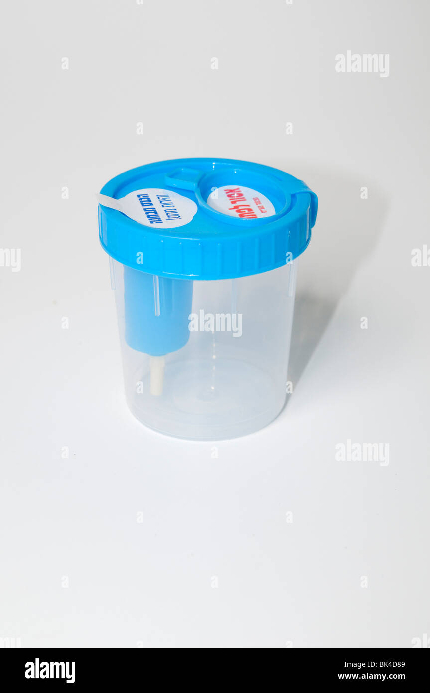 Cutout of an empty sterile Urine sample cup, close-up on white background Stock Photo