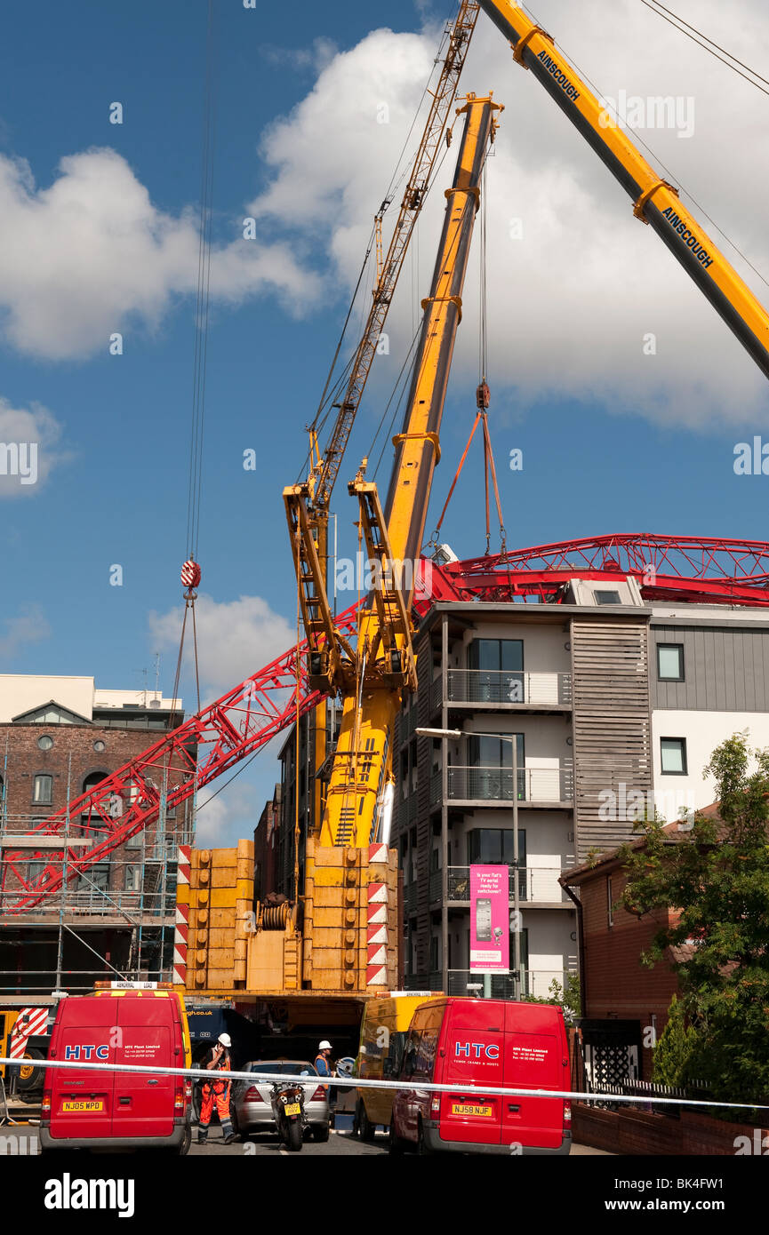 Tower crane collapsed fallen onto roof of apartment block being lifted