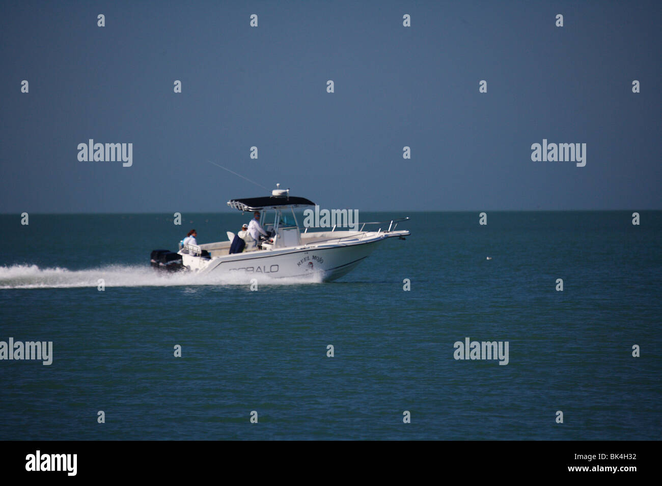 FISHING BOAT SPEEDS ACROSS THE WATER Stock Photo - Alamy
