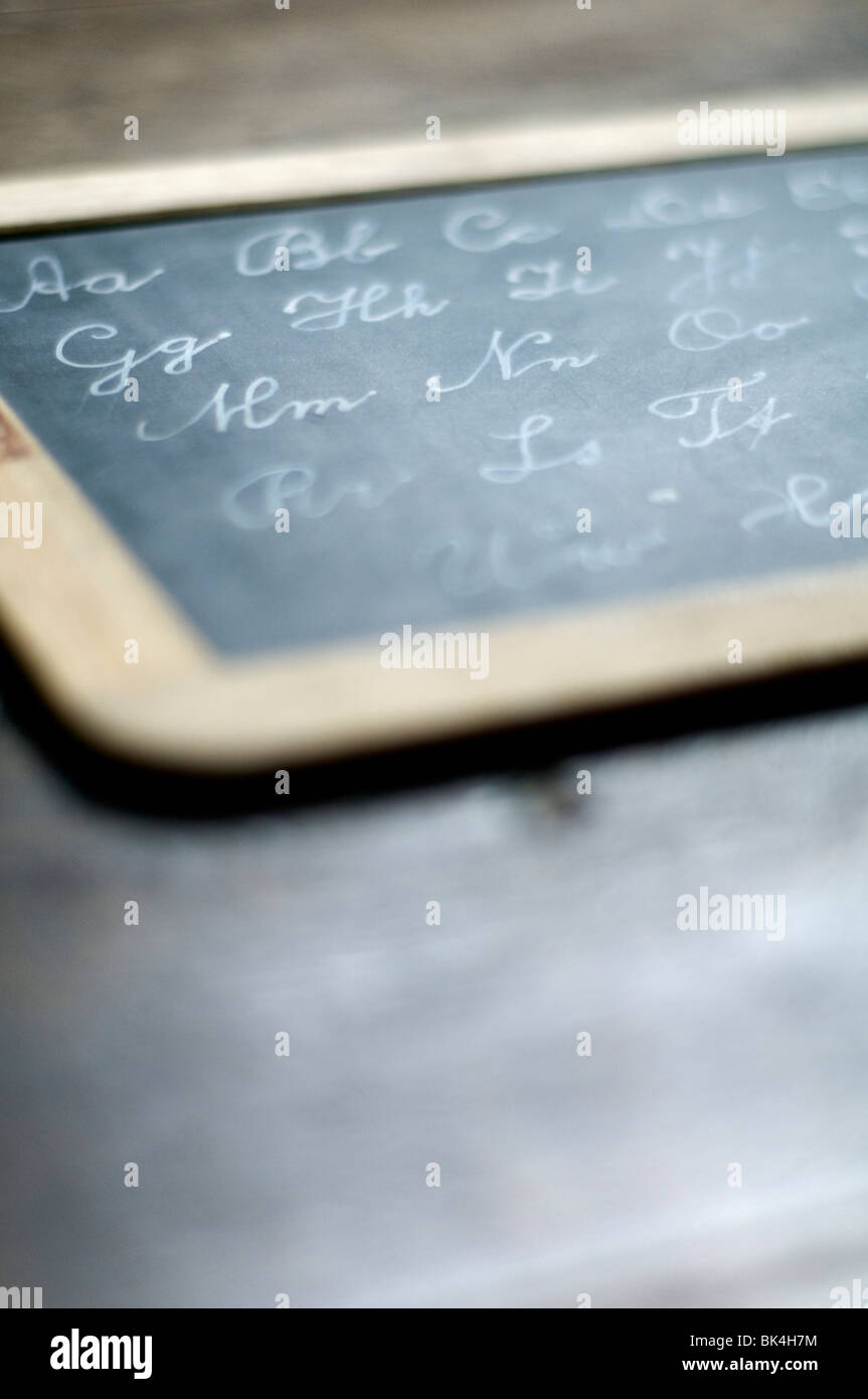 A small blackboard containing the alphabet written in chalk. Stock Photo