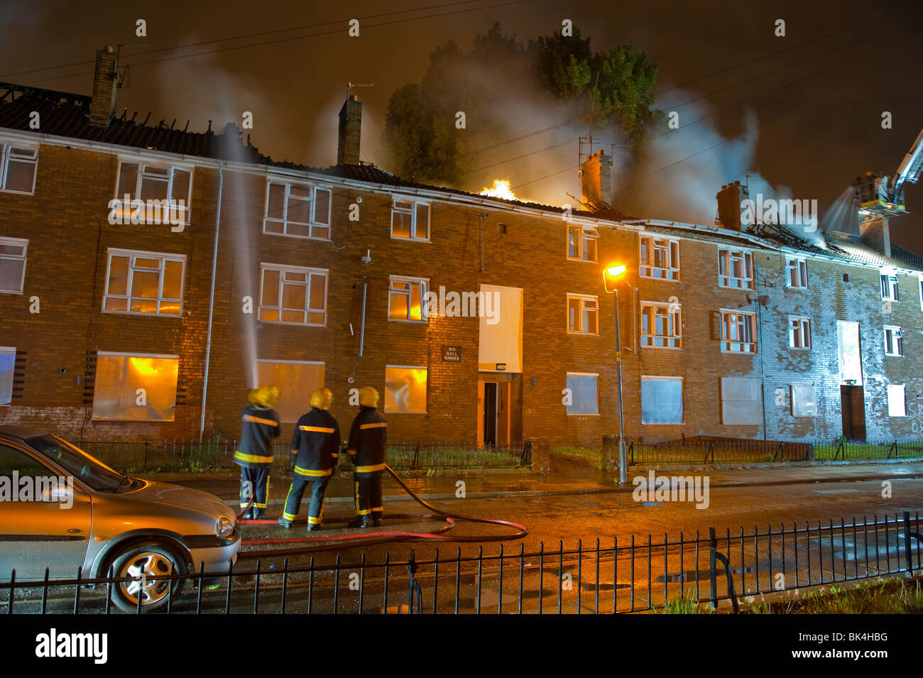 Roof of low rise flats on fire at night Stock Photo Alamy