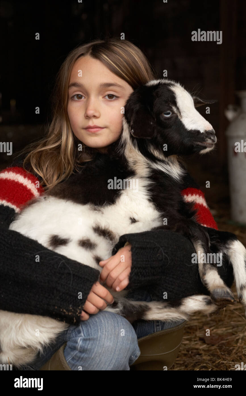 Girl holding baby goat Stock Photo
