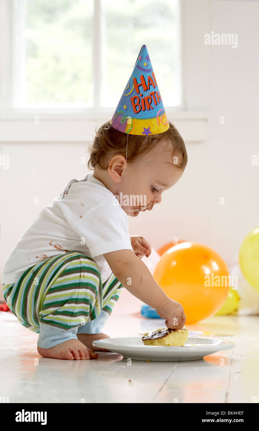 Boy eating cake on his first birthday Stock Photo