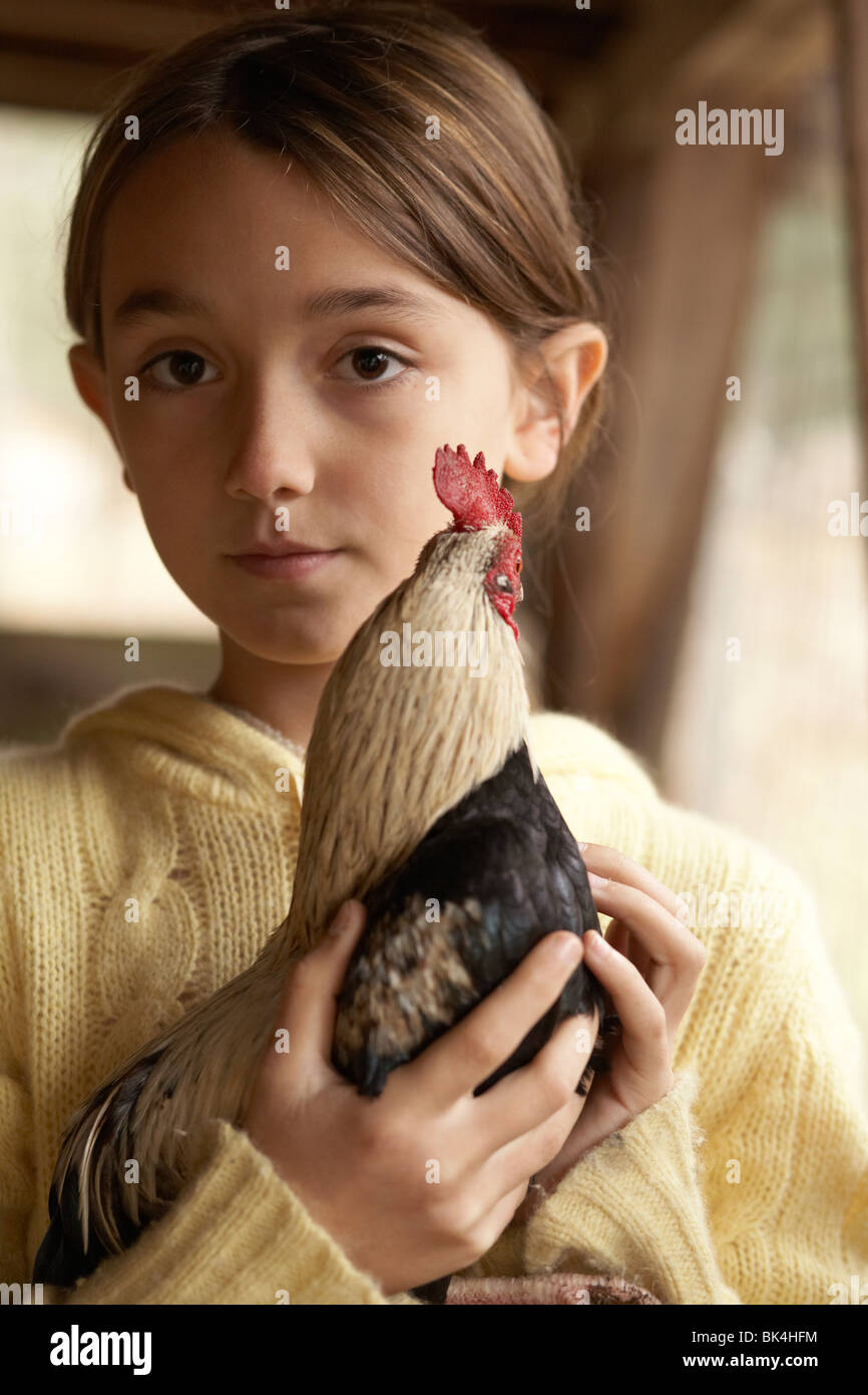 Girl holding her chicken at her farm Stock Photo