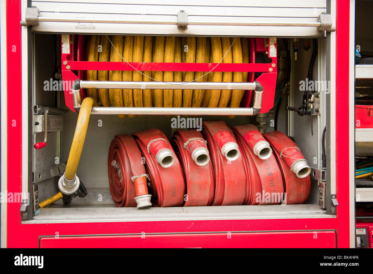Fire hose and hosereel in locker on Engine Stock Photo