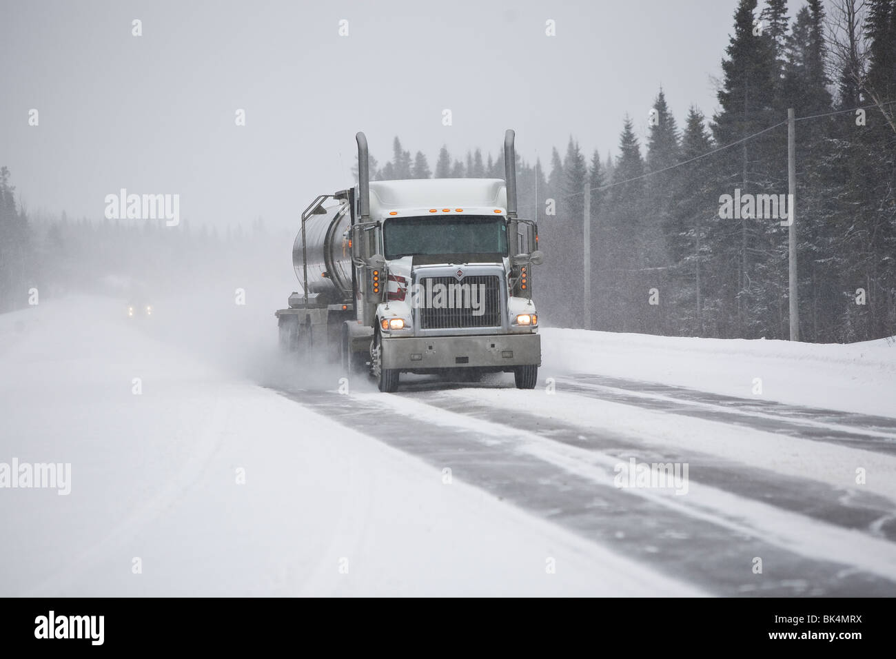 Truck making delivery during a snow storm Stock Photo Alamy