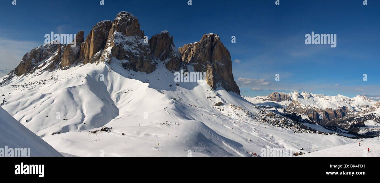 panoramic image of Dolomites mountains in winter, Italy, view of Sassolungo with Col Rodella ski area, Sella Ronda Stock Photo
