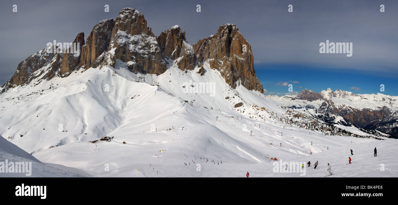 panoramic image of Dolomites mountains in winter, Italy, view of Sassolungo with Col Rodella ski area, Sella Ronda Stock Photo