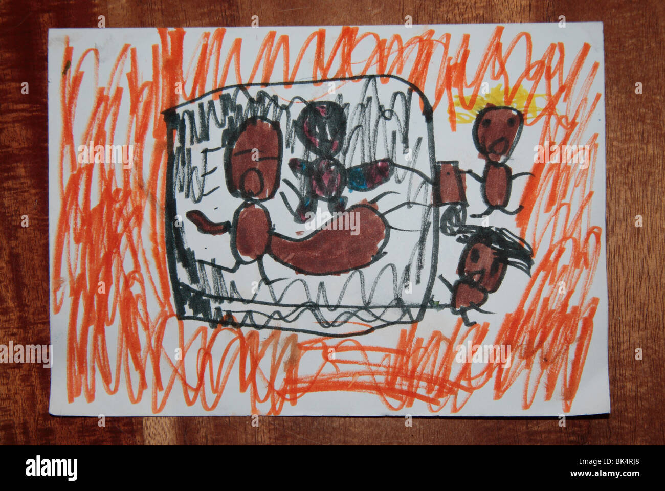 A child's drawing showing a baby inside a burning house. Spiderman has come to the rescue. Stock Photo