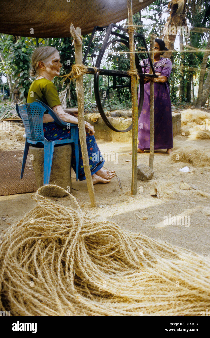 Woman making rope with coco fiber called "coir" in traditional way in a