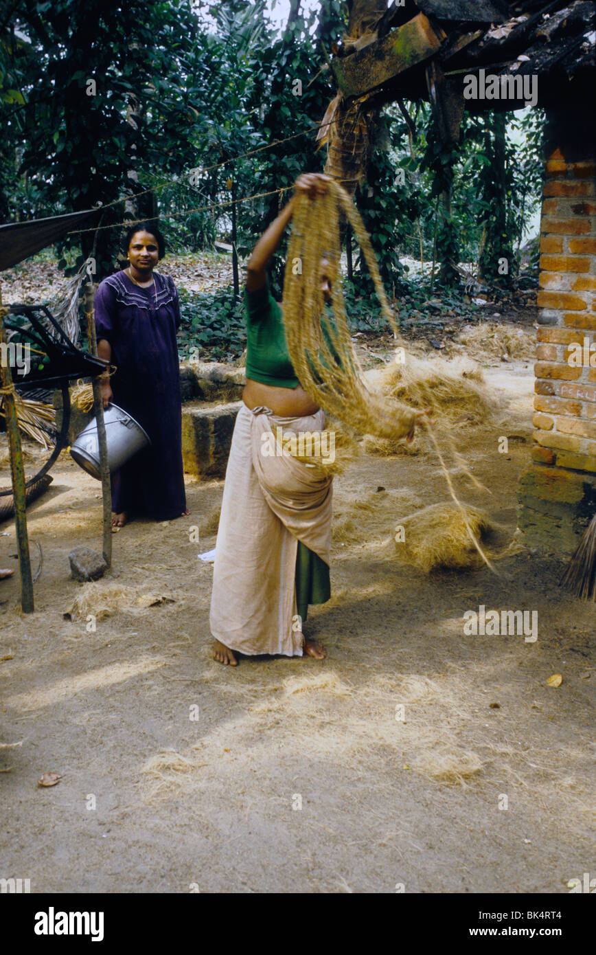 Woman making rope with coco fiber called "coir" in traditional way in a
