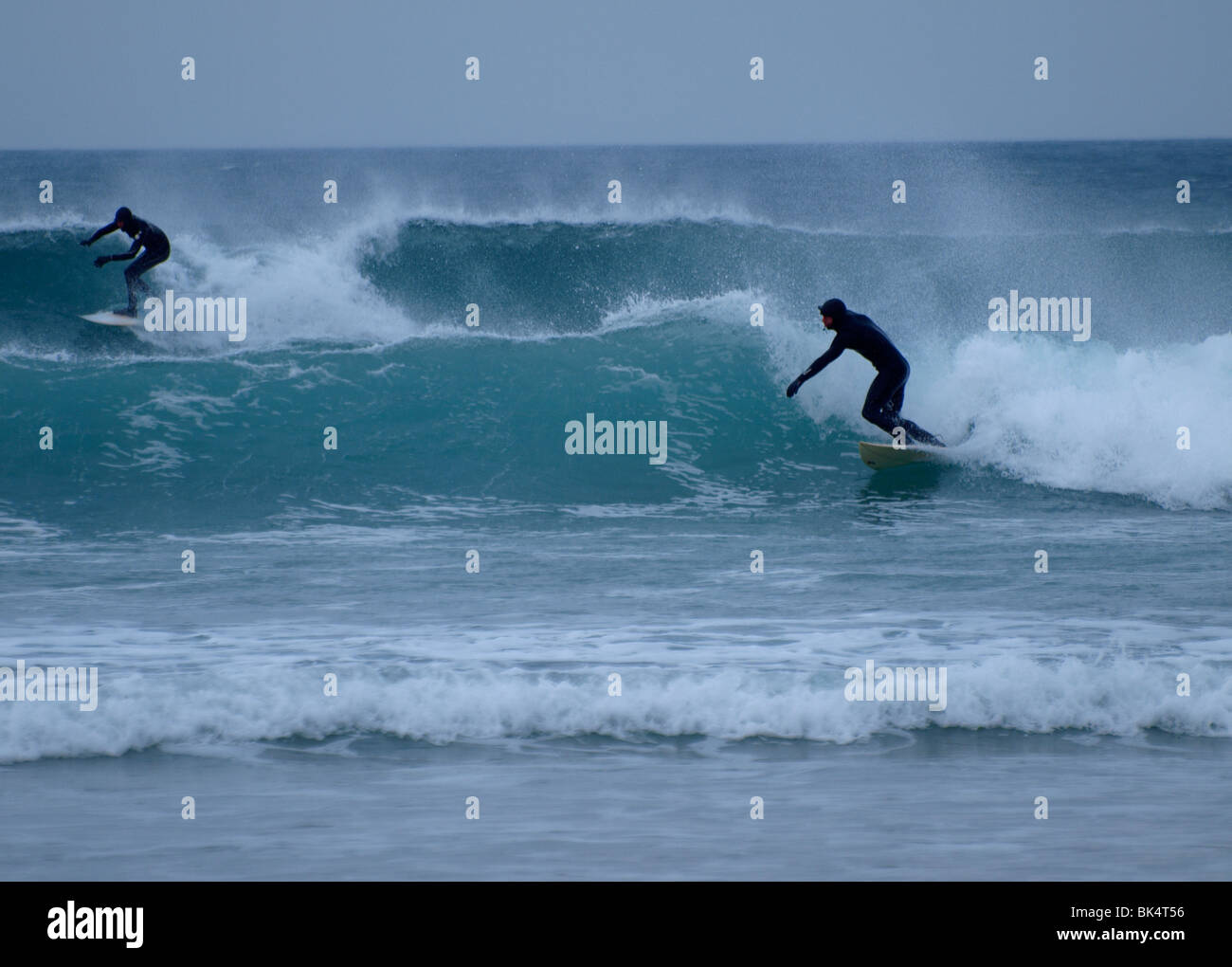 Two surfers winter, Newquay, Cornwall Stock Photo