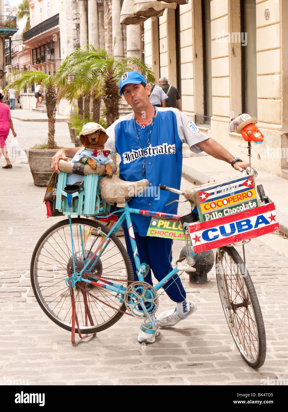 Bicycle Street seller with dog selling chocolate in Old Havana, Cuba Stock Photo