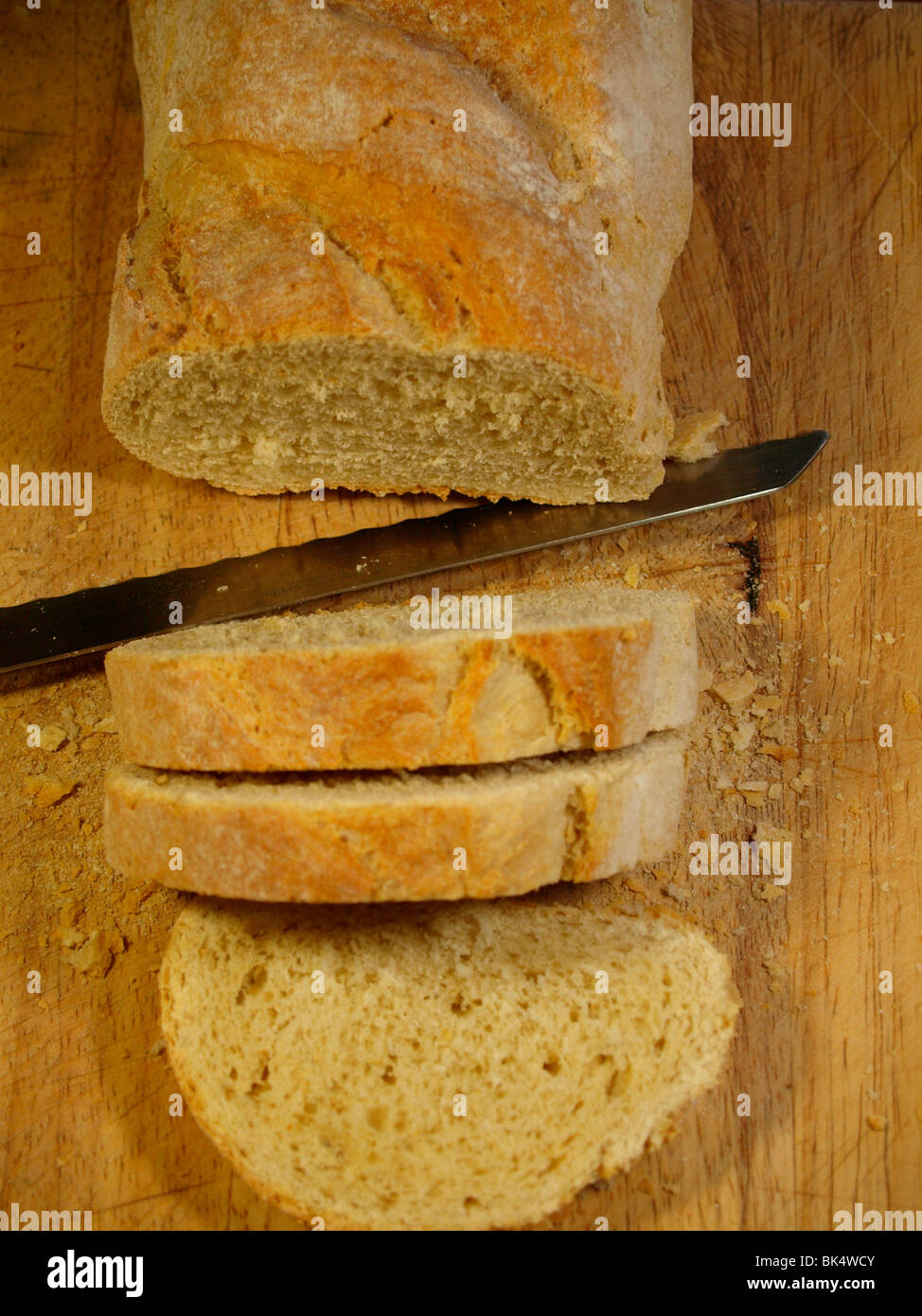 Slicing a French Country Loaf Stock Photo