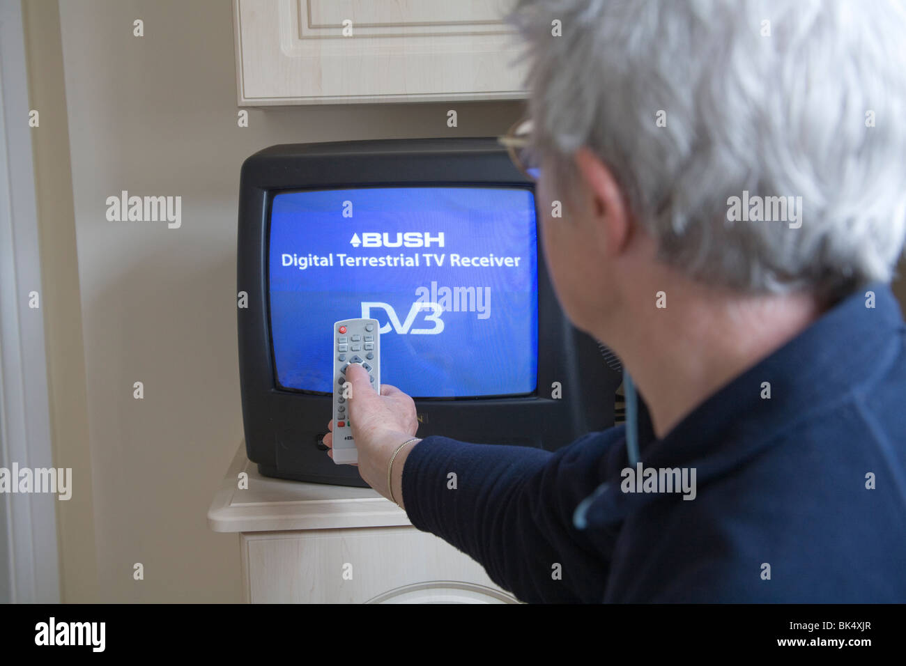 Close up Female senior citizen using a remote control for the Digital