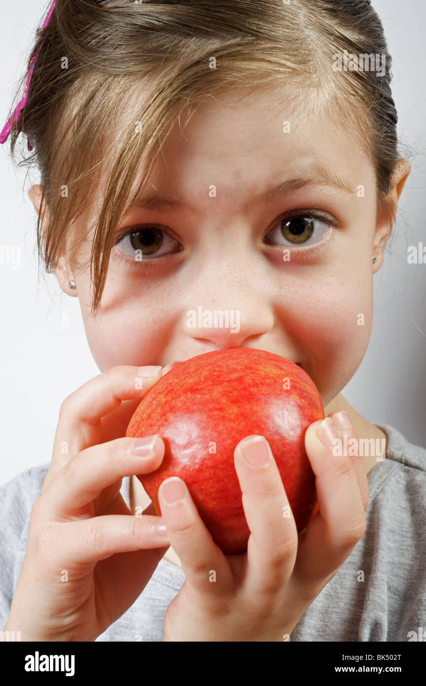 Young girl eating an apple Stock Photo