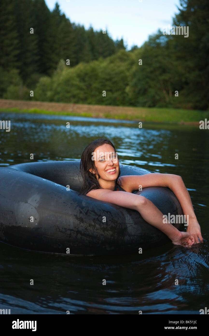 Woman Floating in an Inner Tube, Near Portland, Oregon, USA Stock Photo