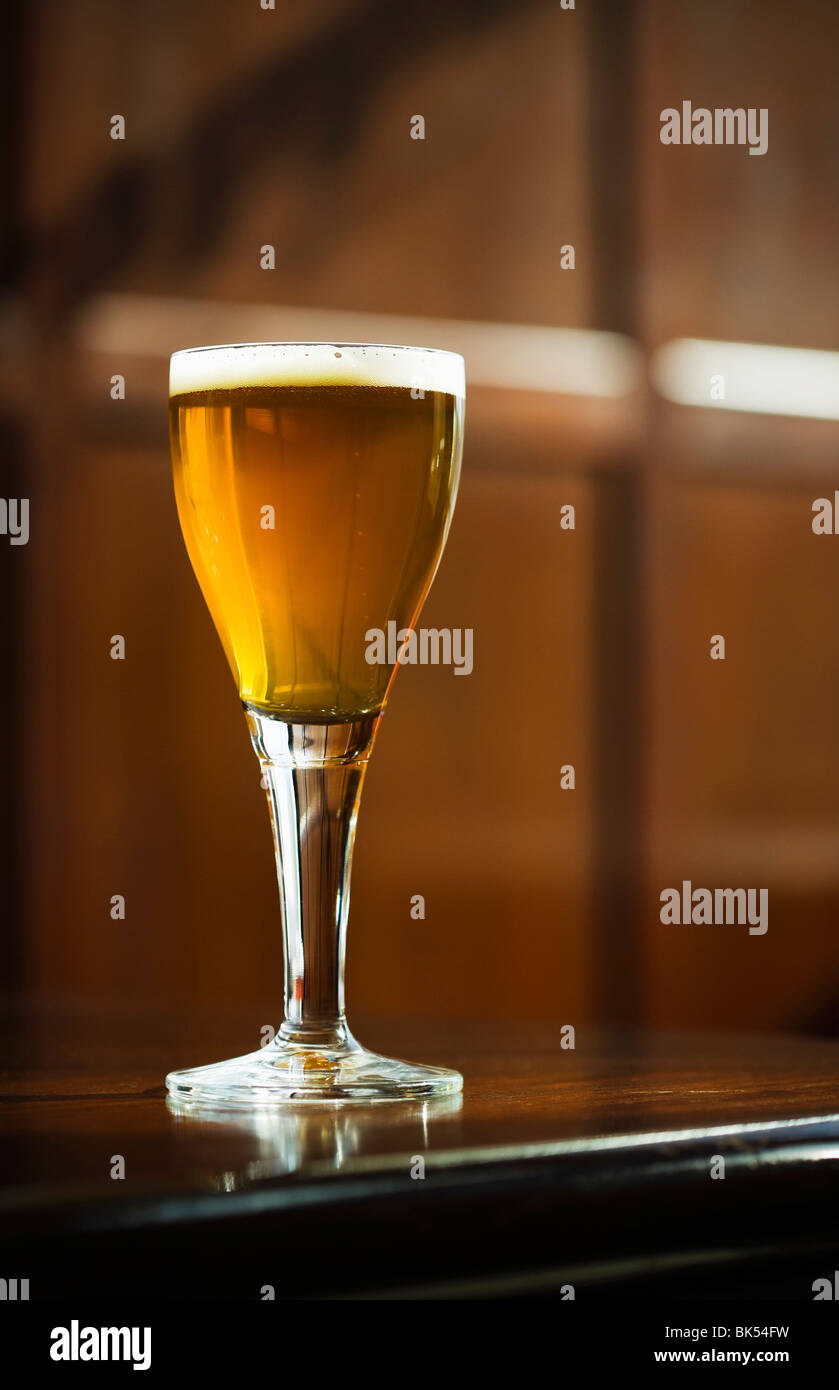 Stemmed Glass of Beer on Counter Stock Photo