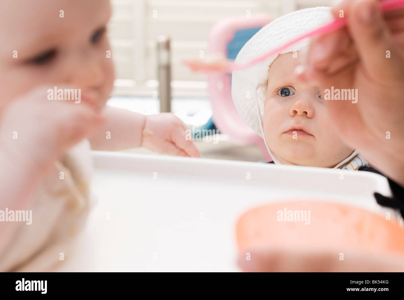 Boy Watching another Child being Fed Stock Photo