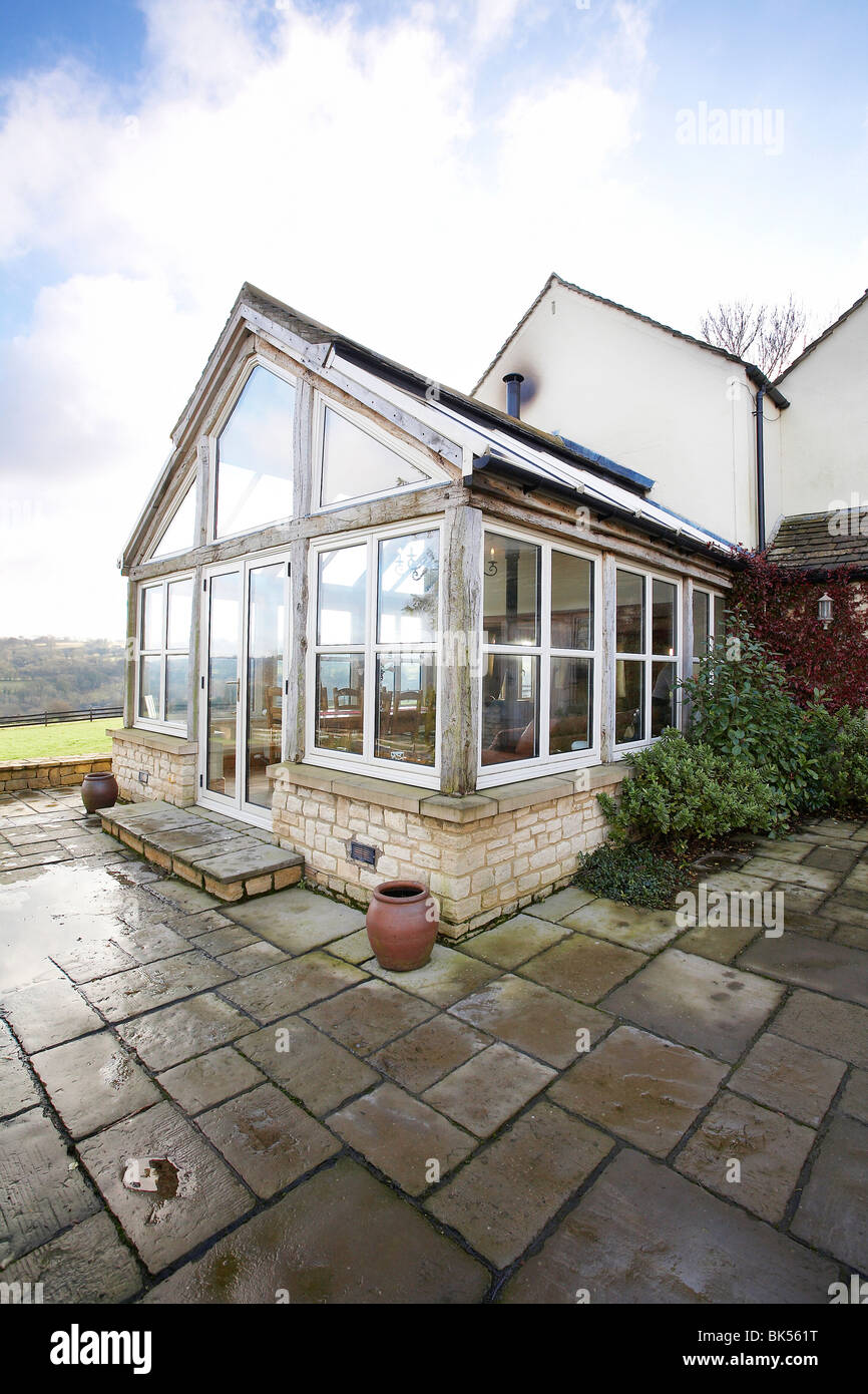 an oak framed orangery type conservatory attached to a house in the