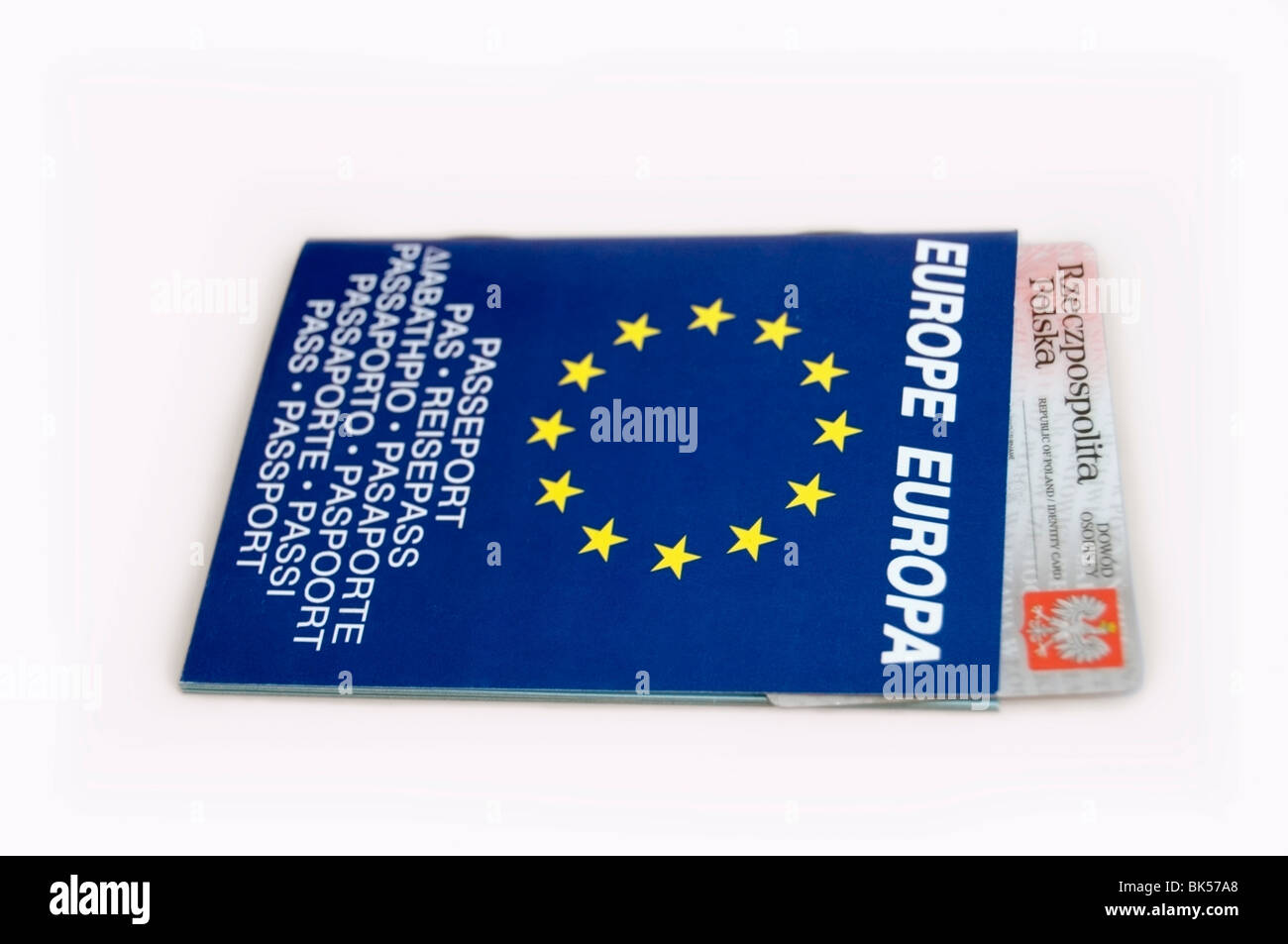 Bilingual European passport, booklet in blue with yellow  stars and Polish identification card on white background, Europe, EU Stock Photo