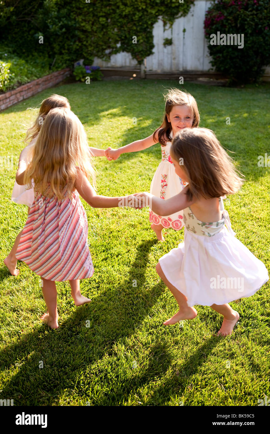 Young girls playing ring around the rosie Stock Photo
