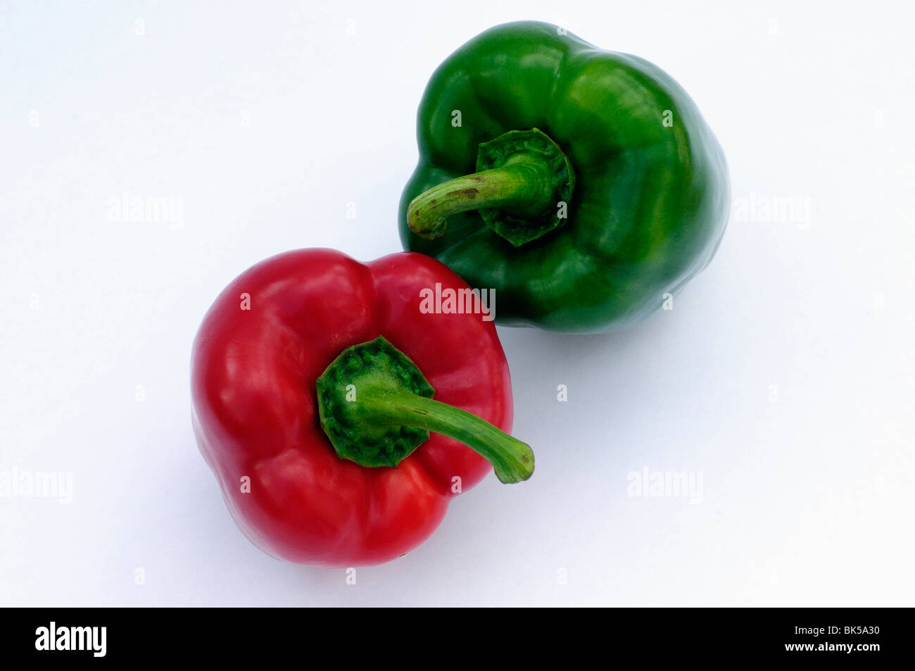 Red and green peppers on white background Stock Photo - Alamy