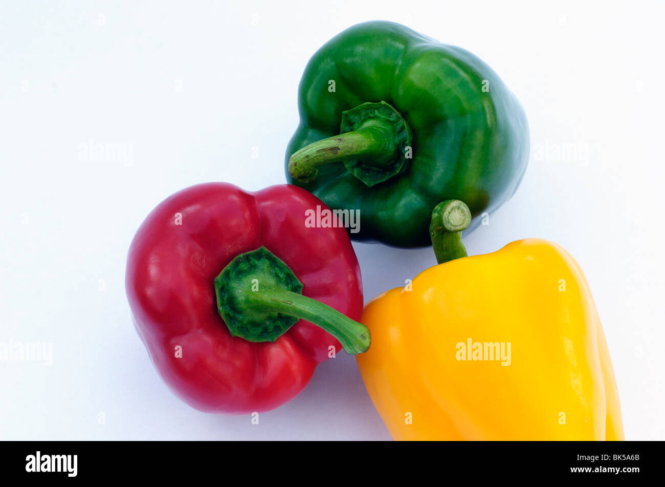 Yellow, red and green peppers on white background Stock Photo - Alamy