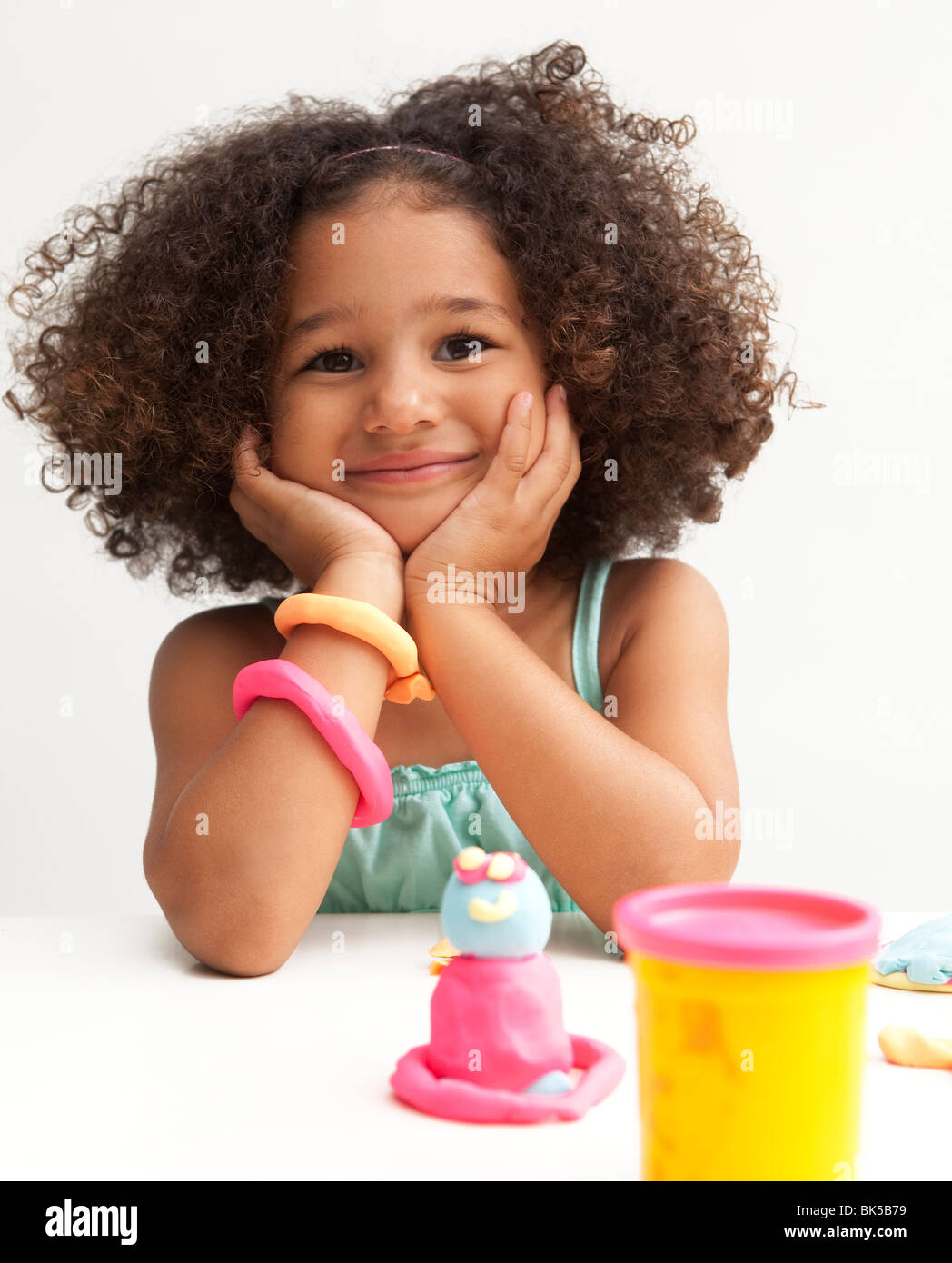 Young girl playing with clay Stock Photo