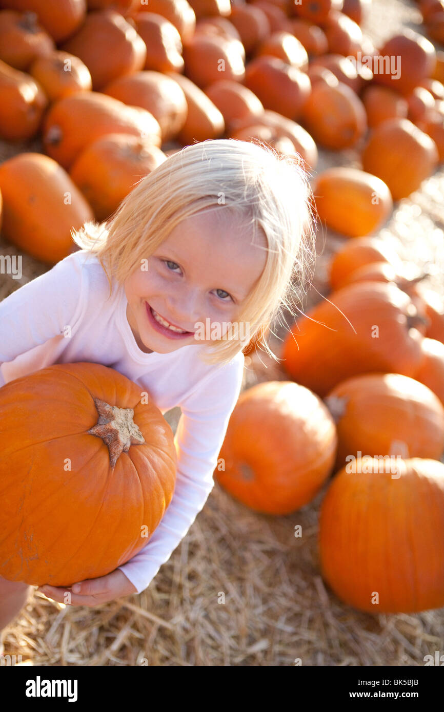 Young girl in pumpkin patch Stock Photo