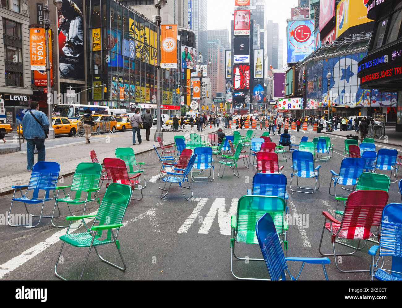 Garden chairs in the road for the public to sit in the pedestrian zone of Times Square, NYC Stock Photo