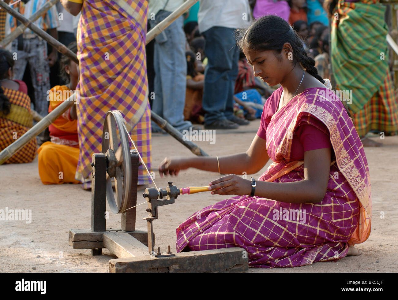 Young woman spinning yarn on a spinning wheel, Tamil Nadu, India