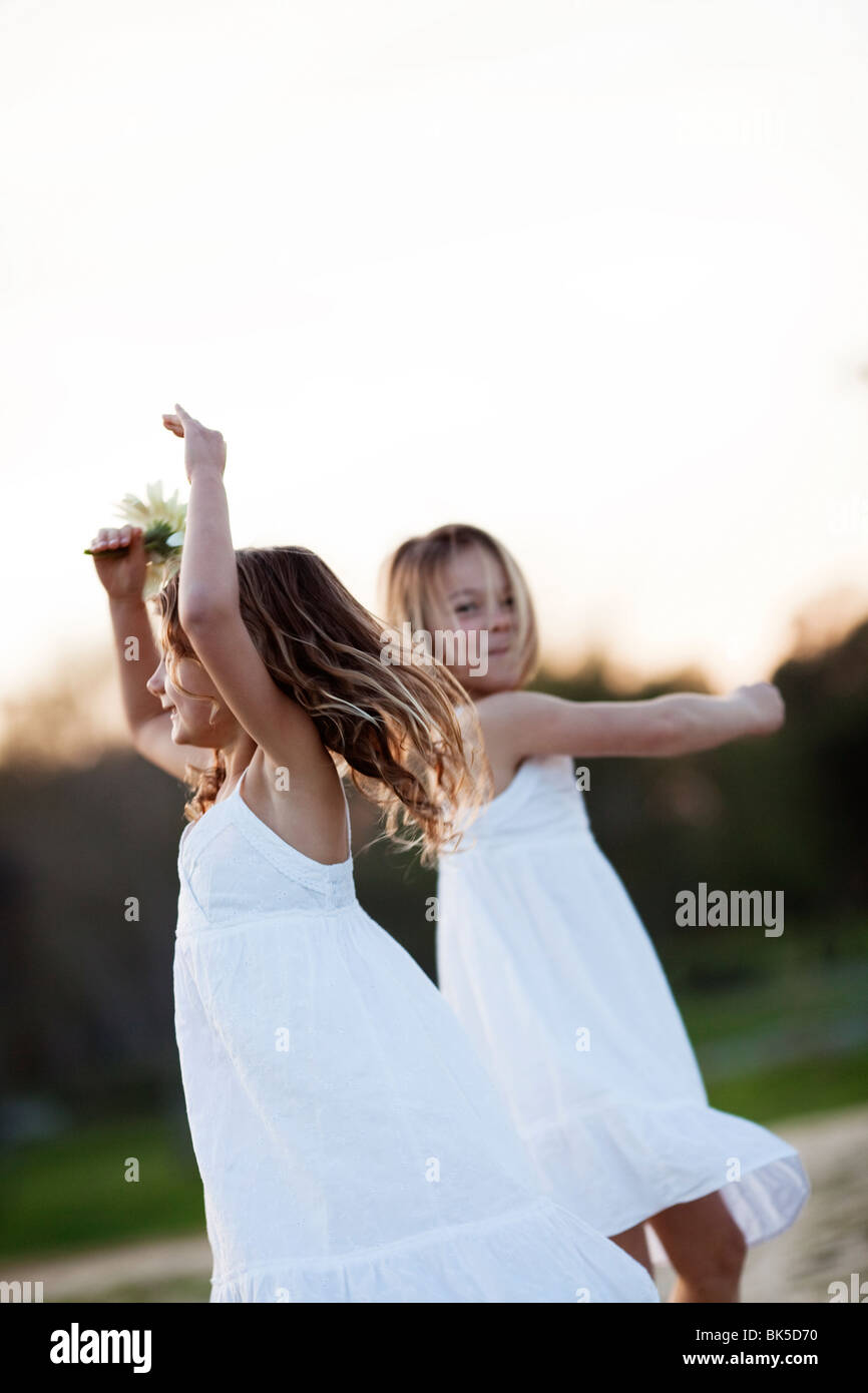 Young girls in white dresses dancing Stock Photo