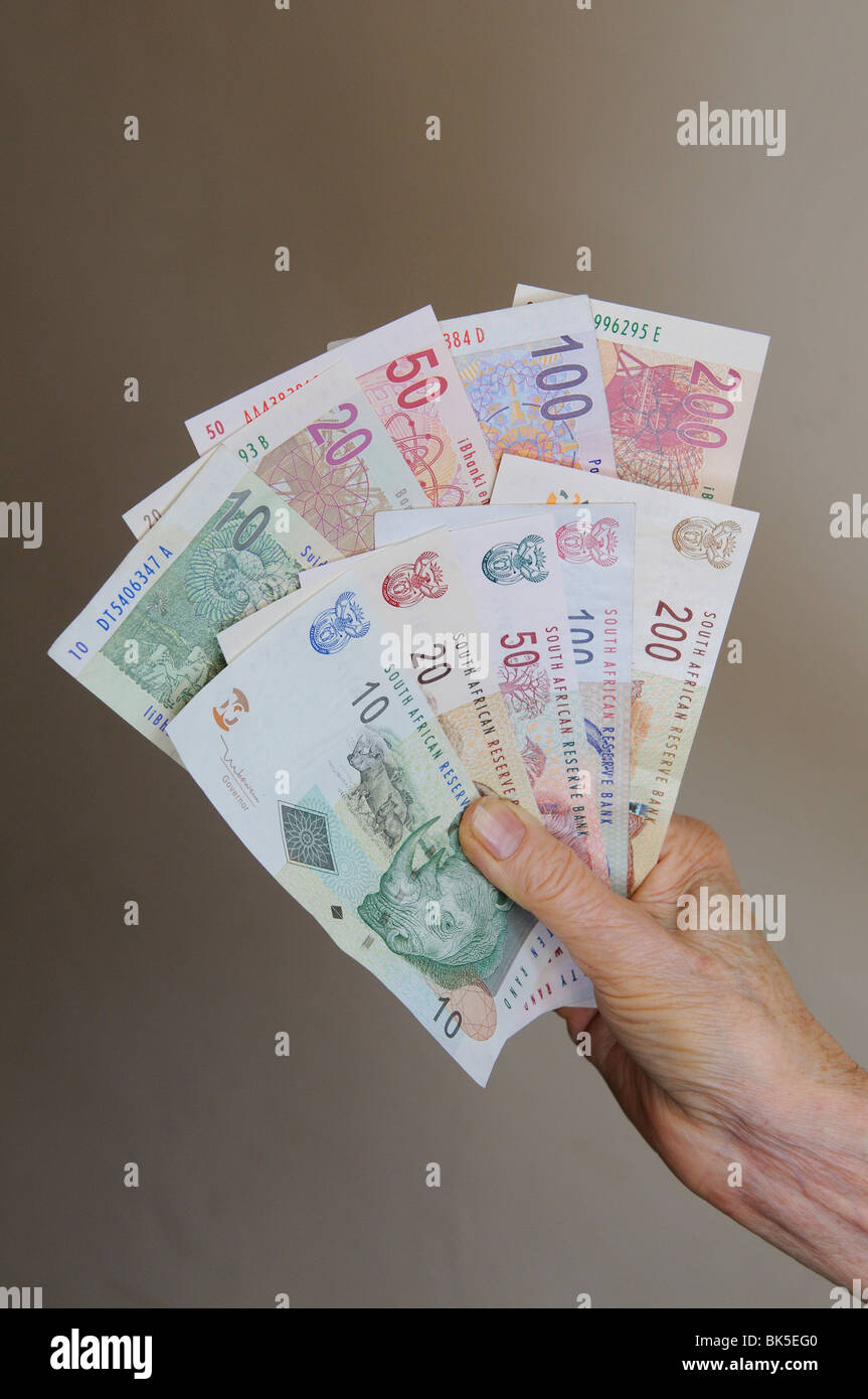 Hand holding South African Rand banknotes Stock Photo