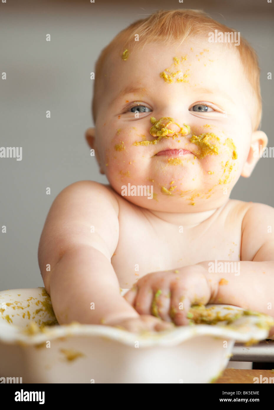 Baby eating bowl of peas Stock Photo - Alamy