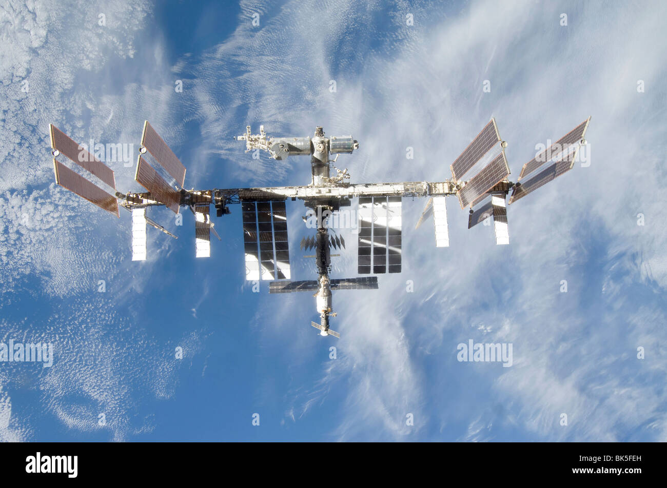 Backdropped part of Earth the International Space Station is seen from Space Shuttle Discovery as the two spacecraft begin Stock Photo