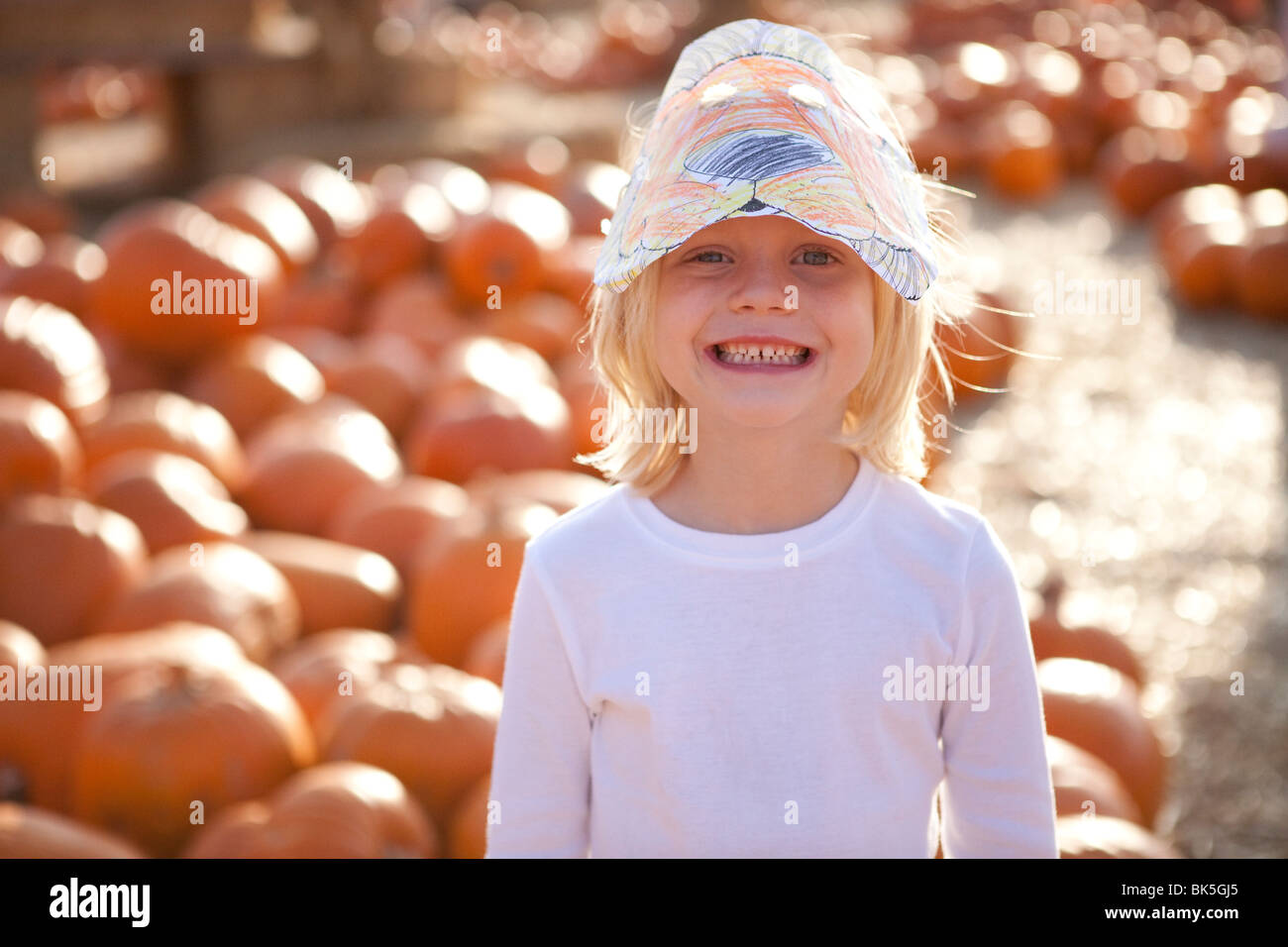 Young girl in pumpkin patch Stock Photo