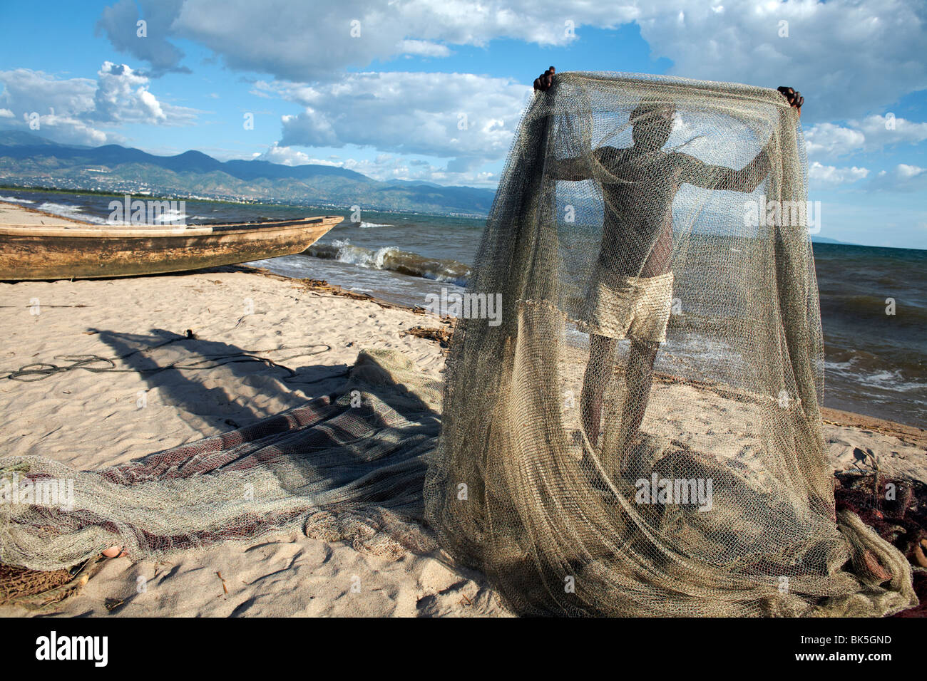 A fisherman tends his nets on Plage des Cocotiers also known as Saga Beach, Lake Tanganyika, Bujumbura, Burundi Stock Photo