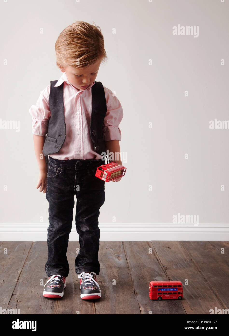 Young boy playing with toy cars Stock Photo - Alamy
