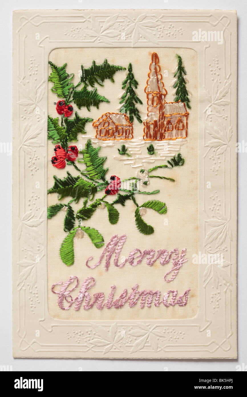 Old Silk Embroidered Christmas Card, featuring holly and mistletoe. Stock Photo