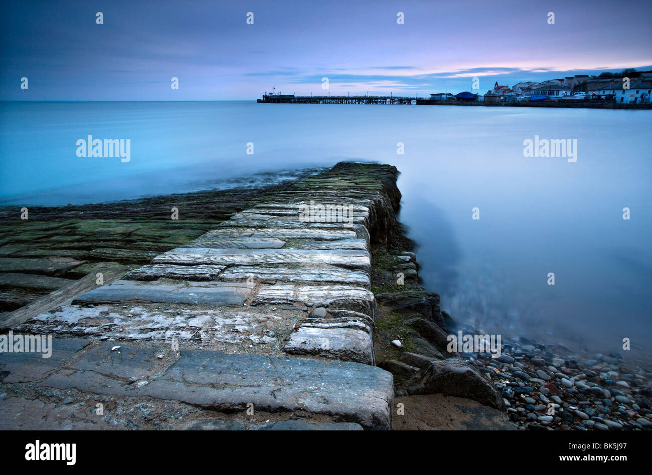 Stone jetty and new pier at dawn, Swanage, Dorset, England, United Kingdom, Europe Stock Photo
